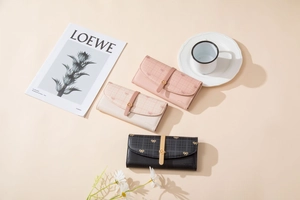 Vue détaillée de trois portefeuilles longs à carreaux en rose, crème et noir