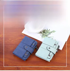 Detail view of compact faux leather wallets with rivet studs and zipper compartments