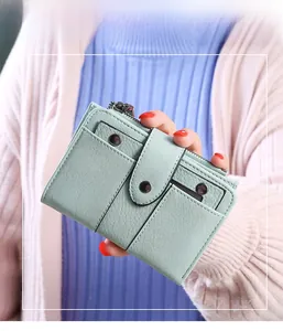 Close-up of mint green litchi grain leather wallet with card slots and snap button