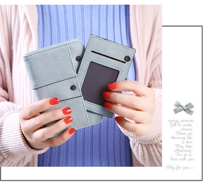 Close-up of light blue pebble grain PU leather wallet with snap button and card holder