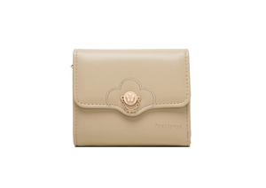 Close-up of beige trifold wallet with gold flower buckle and fine metal chain detail
