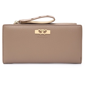 Macro detail of taupe lychee leather texture and golden heart clasp on long wallet
