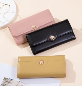 Detailed shot of long PU leather wallets with flower clasp in pink, black, and yellow