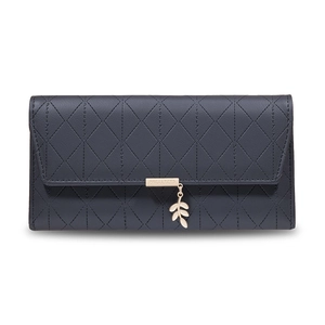 Close-up of long grey PU leather wallet with diamond quilting and gold leaf pendant