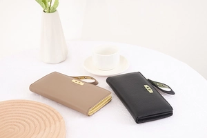 Detailed view of long leather wallets featuring heart buckles and detachable wrist straps