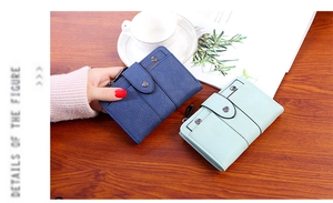 Detail of minimalist leather wallets with rivet closure and side zipper coin pocket