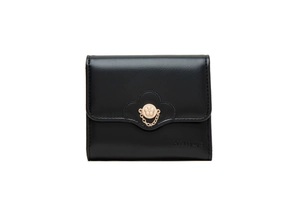 Detail of a black trifold wallet featuring a golden floral clasp and textured faux leather
