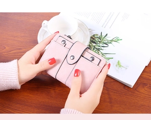 Pink matte PU leather wallet held by hands showing snap closure and zipper pocket detail