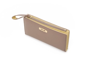 Close-up of long women's wallet in purple litchi leather with yellow interior detail