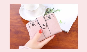 Detail of pink PU leather short wallet with metal rivet studs and snap button closure