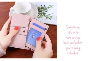 Detail of pink faux leather wallet with removable card slot and elegant snap closure