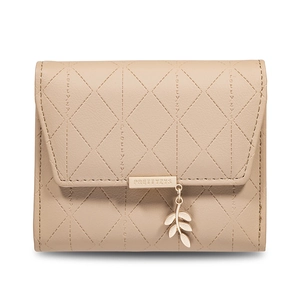 Detail view of beige quilted wallet with brand metal plaque and gold leaf pendant