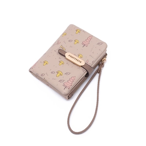 Detail of beige PU leather wallet featuring forest mushroom prints and a wrist strap
