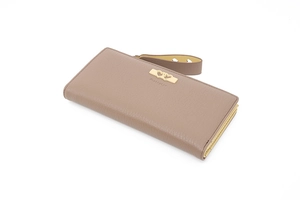 Macro view of long taupe wallet showing lychee texture and golden heart hardware