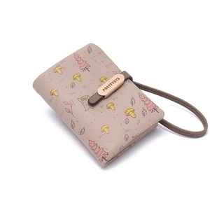 Detail shot of taupe PU leather wallet with forest prints and wooden texture clasp