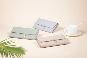 Detailed view of long PU leather wallets in green, grey, and beige with leaf charms