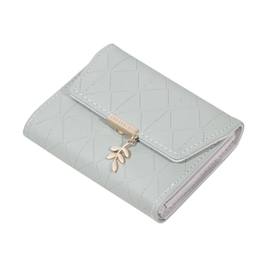 Detail of mint green PU leather wallet featuring quilted stitching and leaf pendant charm
