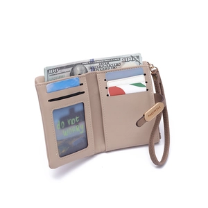 Detail view of khaki PU leather wallet with wristlet strap and internal card slots
