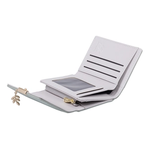 Close-up of short tri-fold wallet featuring card slots and a leaf-shaped metal pendant