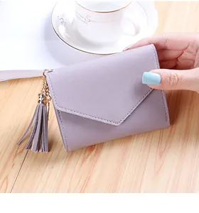 Lavender envelope wallet detail featuring smooth PU leather texture and tassel charm