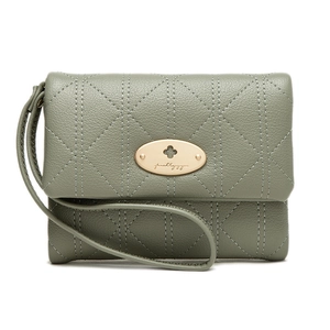 Close-up of sage green quilted leather wallet featuring a gold oval metal buckle