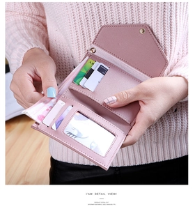 Macro view of short PU leather wallet with card slots, ID window and snap closure