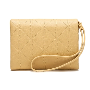 Detail of beige quilted faux leather clutch with wristlet strap and pebble texture