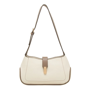 Detailed close-up of cream leather shoulder bag with lychee texture and gold buckle