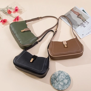 Three leather underarm bags in green, black, and brown with gold buckles and lychee texture