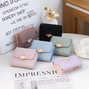 Flat lay of colorful PU leather short wallets with golden leaf buckle and zippers