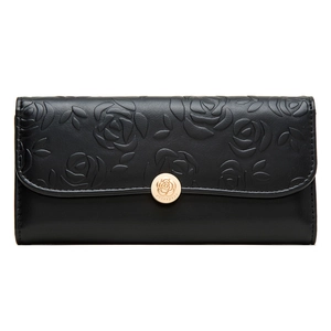 Close-up of 3D embossed rose floral pattern and gold metal clasp on long black wallet