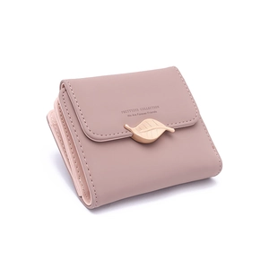 Detail of dusty pink tri-fold wallet featuring gold leaf buckle and engraved text