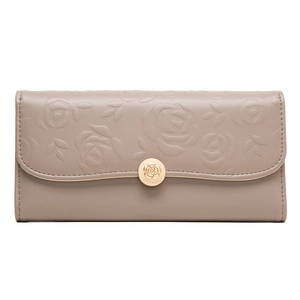 Macro shot of 3D rose flower embossed texture on mauve long leather wallet with gold buckle