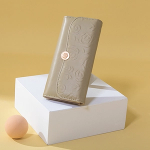 Detail of olive green PU leather wallet with 3D embossed rose floral pattern and gold clasp
