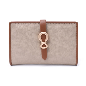 Close-up of beige pebble leather wallet with brown strap and gold infinity buckle