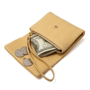 Pale yellow quilted leather wallet for women with wristlet strap and spacious compartments