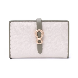 Close-up of contrast leather wallet with gold metal hardware and pebbled texture