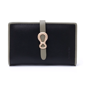 Detail of bifold wallet in black crossgrain leather with green strap and gold logo