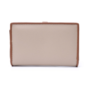 Close-up of beige lychee grain leather wallet with tan contrast stitching and metal zipper