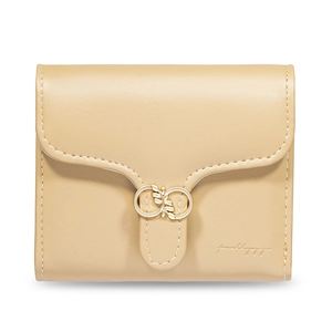 Detailed macro view of beige PU leather wallet with elegant gold leaf buckle and texture