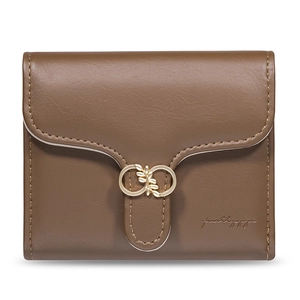 Detail of brown faux leather wallet with gold metal buckle and precision stitching