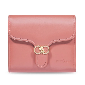 Close-up of pink faux leather wallet featuring golden leaf clasp and fine texture