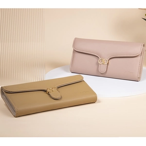 Detail view of pink and khaki PU leather wallets with elegant golden interlocked hardware