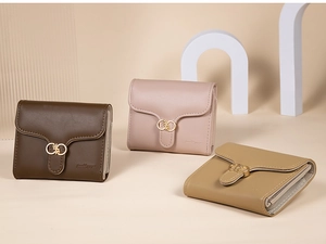 Detailed view of three-fold leather wallets with gold rings and side zipper closures