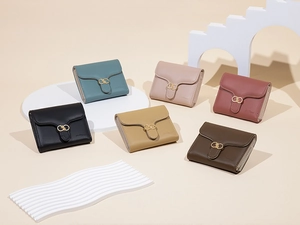 Close-up of compact faux leather wallets in six colors with metallic double ring clasps