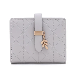Detail of grey quilted leather wallet with rose gold leaf charm and buckle closure