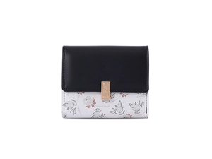 Detailed view of floral pattern and gold metal buckle on a trifold wallet for women