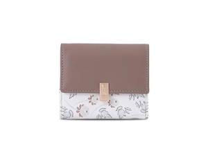 Detailed macro shot of floral PU leather wallet with metallic leaf snap button closure