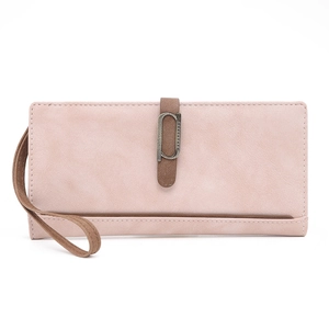 Close-up of matte dusty rose long wallet with brown wristlet strap and retro metal ring