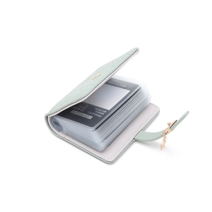 Detail view of the light green PU card wallet showing internal card slots and leaf buckle